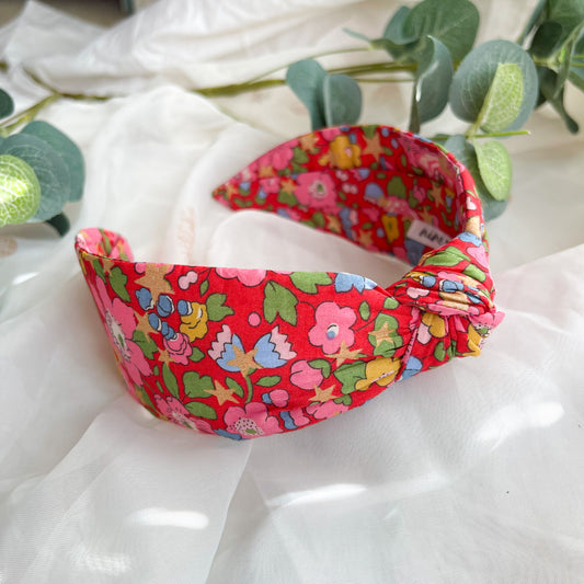 Liberty London Betsy star print knot headband for women, comfortable and flexible fabric hairband, featuring a floral design, is the perfect ladies hair accessory, combining the style of a knotted hairband with the practicality of a wide headband for a chic and secure look.